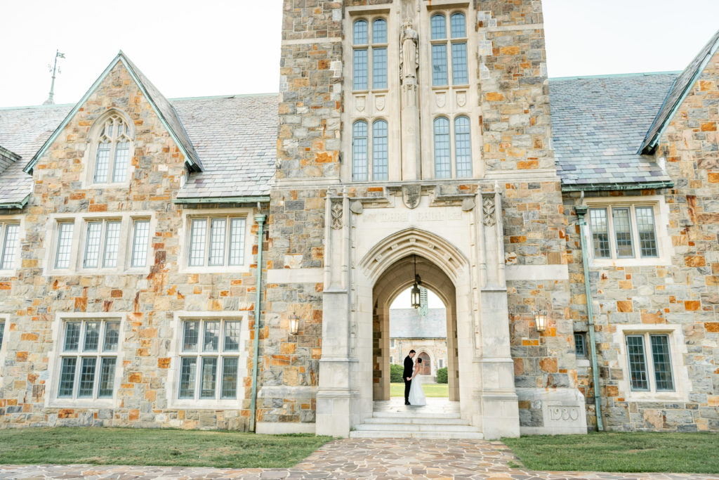Newly married couple kissing under covered walkway at Berry College in Rome Georgia