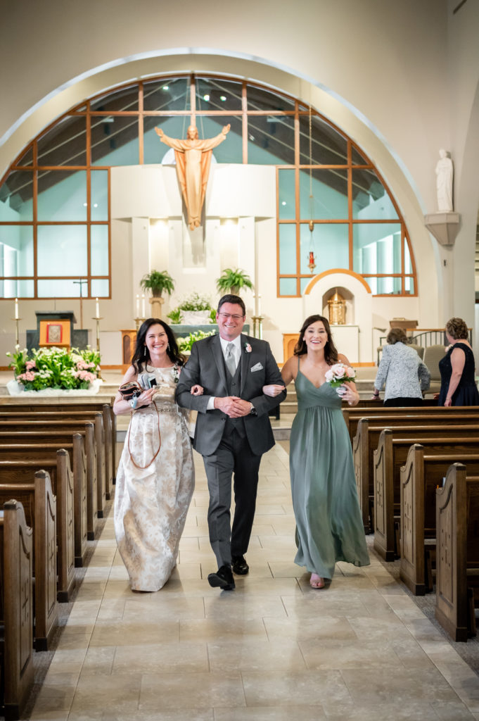 Bride and groom exchanging rings at St Andrew Catholic Church in Roswell, GA