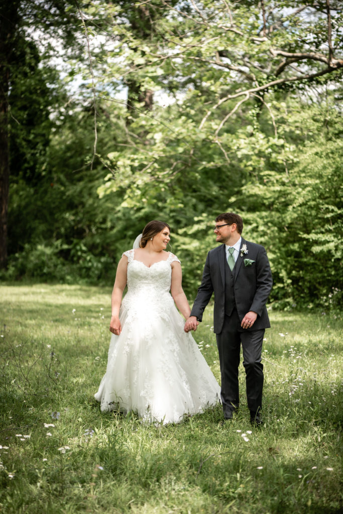 Bride and groom walking in the park in Roswell, GA