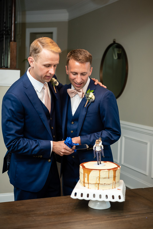 wedding couple cutting their caramel wedding cake in Charlotte North Carolina