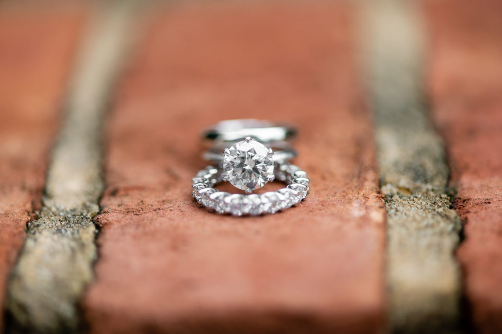 Wedding rings positioned on brick at intimate, backyard wedding in Marietta GA