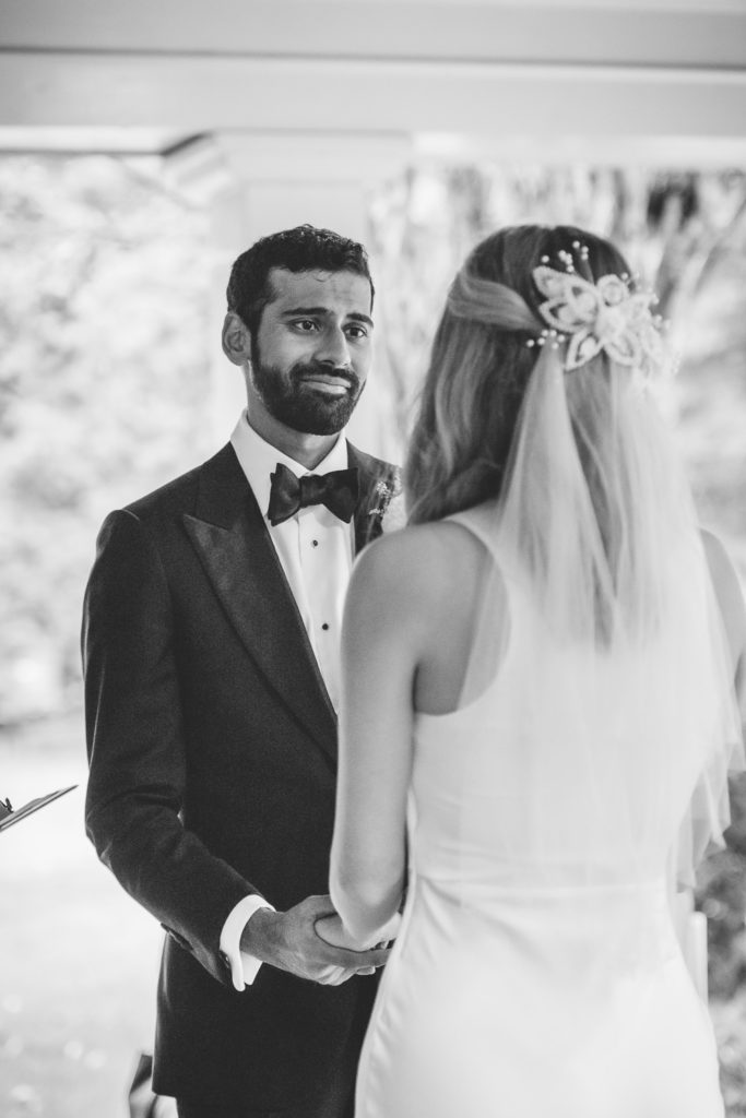 Groom gazing at bride at the alter at intimate, backyard wedding in Marietta GA