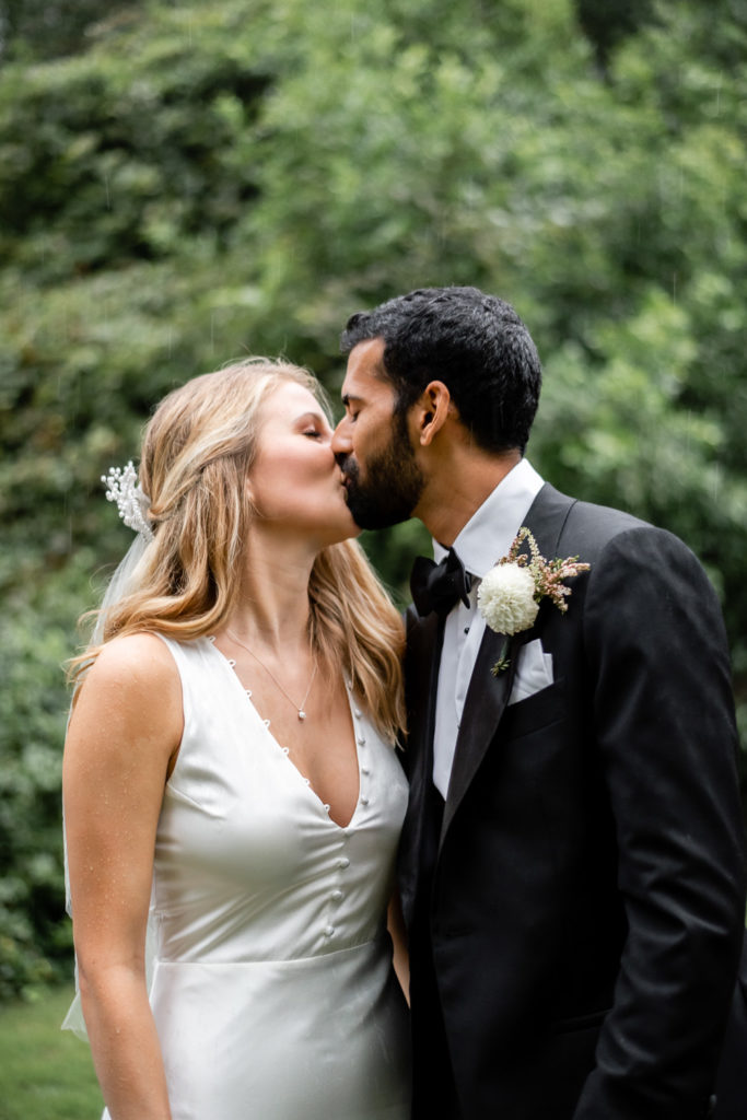 Bride and groom kissing at intimate, backyard wedding in Marietta GA