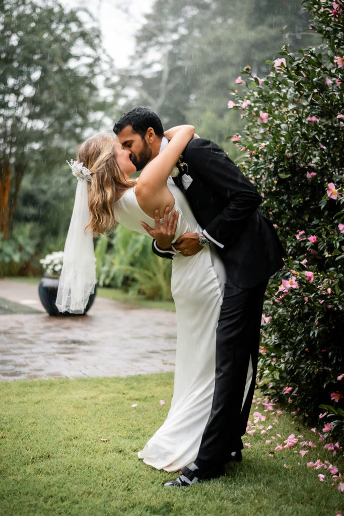 Bride being dipped and kissed by groom at intimate, backyard wedding in Marietta GA