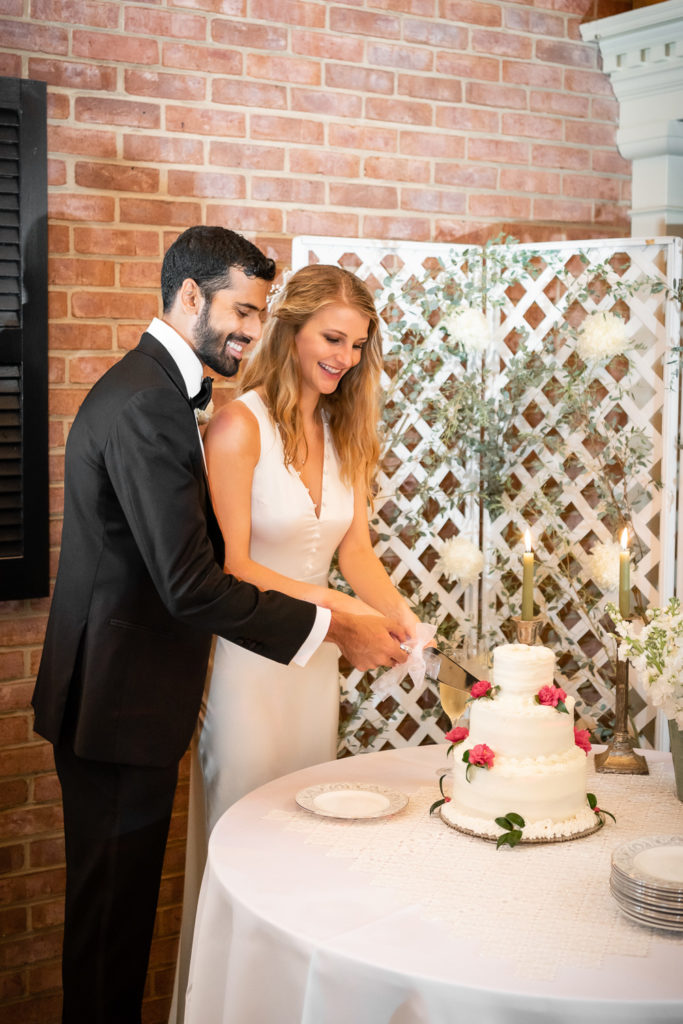 Bride and groom cutting the wedding cake at intimate, backyard wedding in Marietta GA
