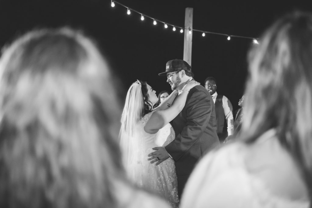 Bride and groom sharing final dance with guests circled around them at reception at wedding at The Gavi Estate and Barn in Forsyth GA