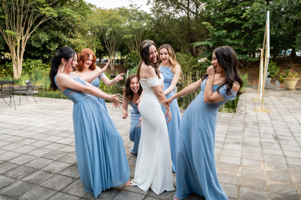 bridesmaids laughing with bride on the wedding day at The Hudgens Center for Art and Learning in Atlanta Georgia