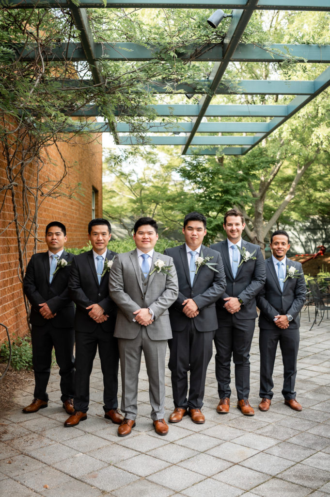 groom and groomsmen standing in the garden on the wedding day at The Hudgens Center for Art and Learning in Atlanta Georgia
