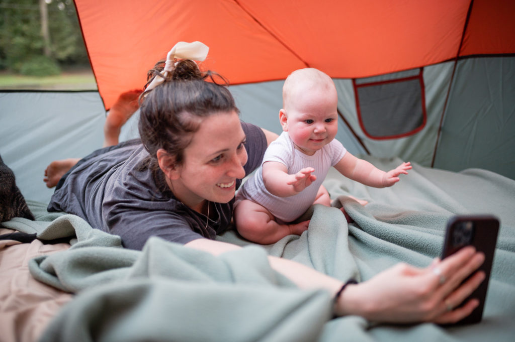 Mom playing with baby while tent camping