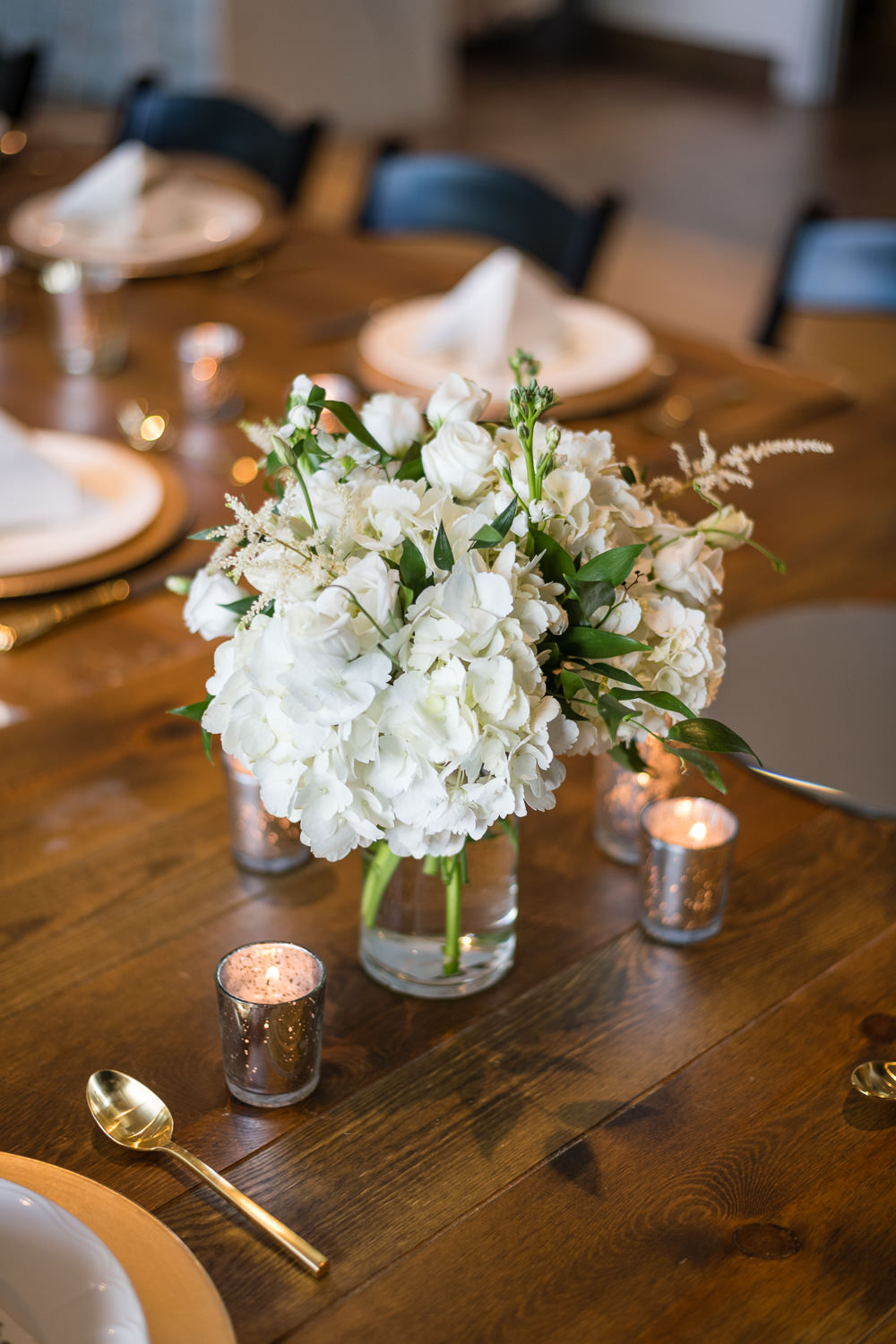 indoor reception with white floralsat surprise rooftop wedding in midtown atlanta