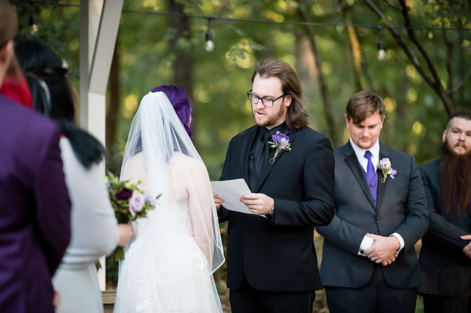 groom reading vows at alter at wedding at The Gardens at Kennesaw Mountain in Atlanta Georgia