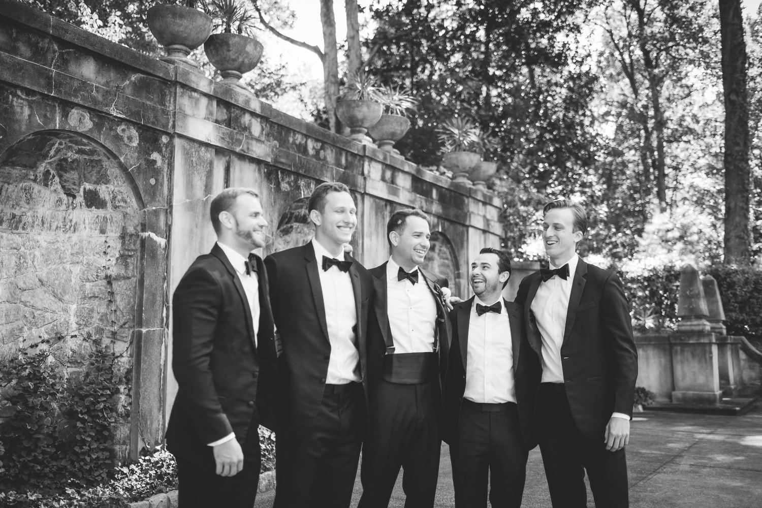 groom and groomsmen laughing at wedding at The Swan House at the Atlanta History Center in Atlanta Georgia